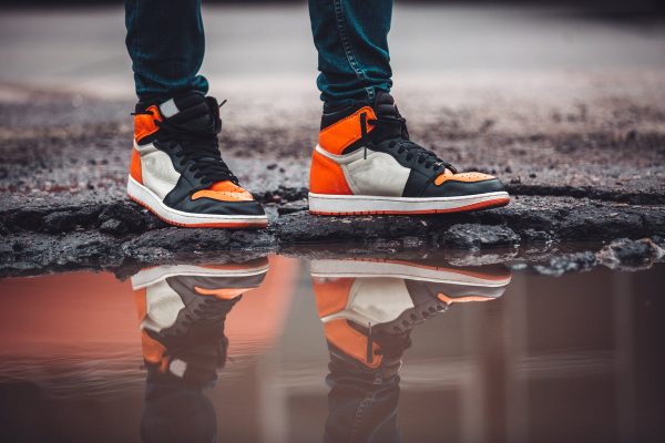 bright-fashion-sneakers-reflect-in-puddle-on-asphalt-street Sneakers 020