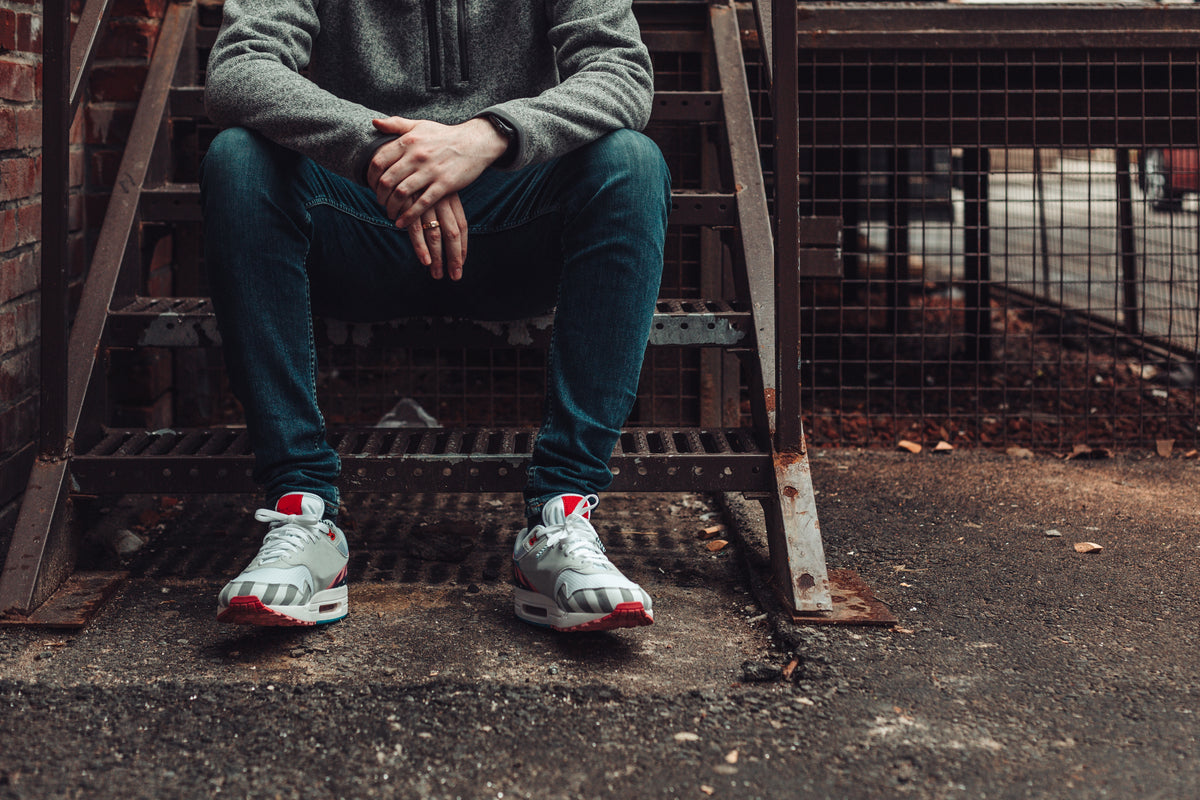 man-in-dark-denim-and-fashion-sneakers-sitting-on-stairwell Sneakers 021
