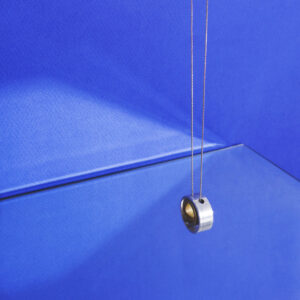 modern-jewelry-hanging-on-blue-with-reflection Κόσμημα Μοντέρνο Μπλε