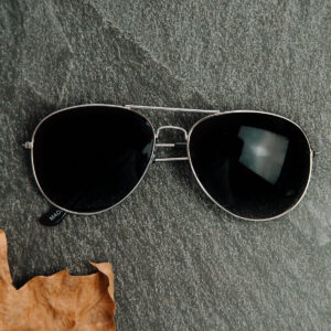 pair-of-silver-framed-sunglasses-on-a-stone-surface Γυαλιά Ηλίου Ασημί