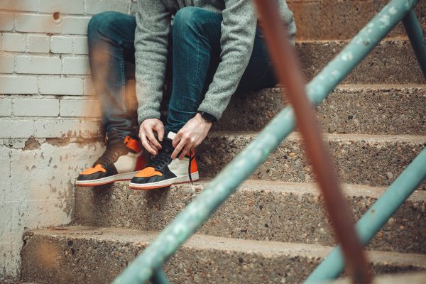 sitting-for-a-moment-to-tie-the-laces-of-fashion-sneakers Sneakers 019