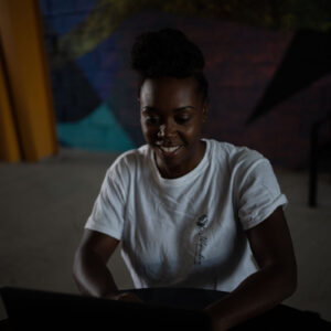 woman-in-white-shirt-sits-at-a-table-looking-at-computer Πουκάμισο Λευκό 010