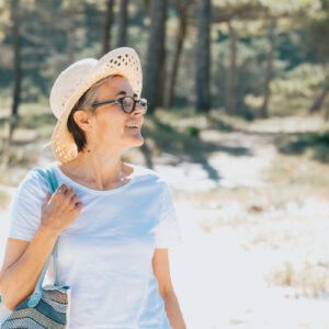 woman-walks-outdoors-during-summer-holding-a-beach-bag Τσάντα Καλοκαιρινό