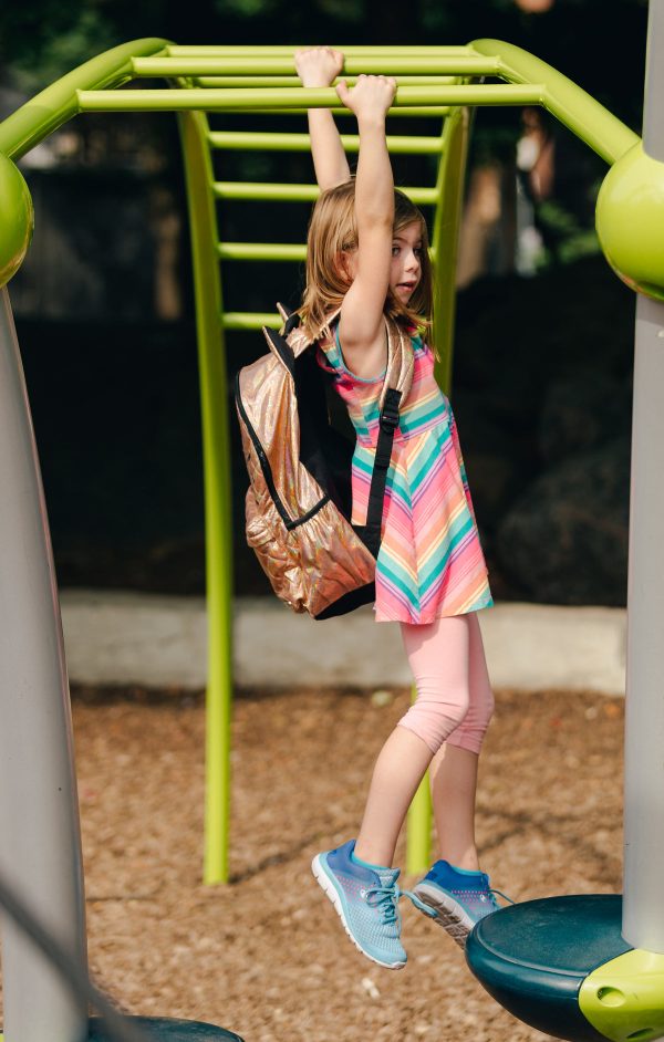 young-girl-swinging-on-bars-with-backpack Σακίδιο Πλάτης 003